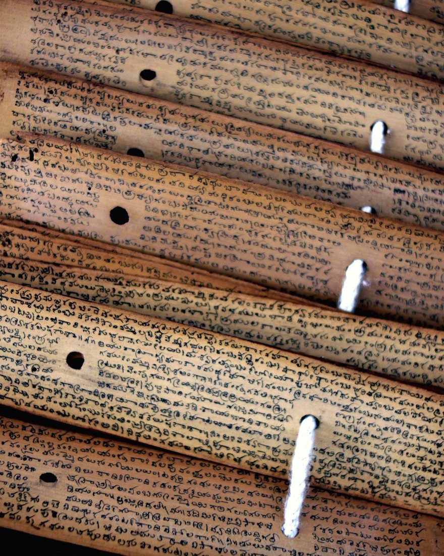 Old Tamil script inscribed across a palm leaf