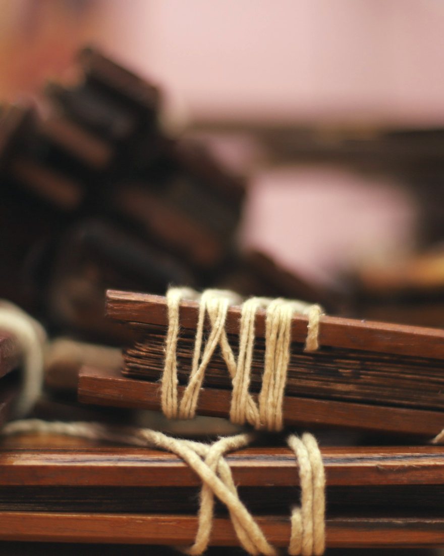 A palm-leaf bundle bound between timber covers with cotton cord