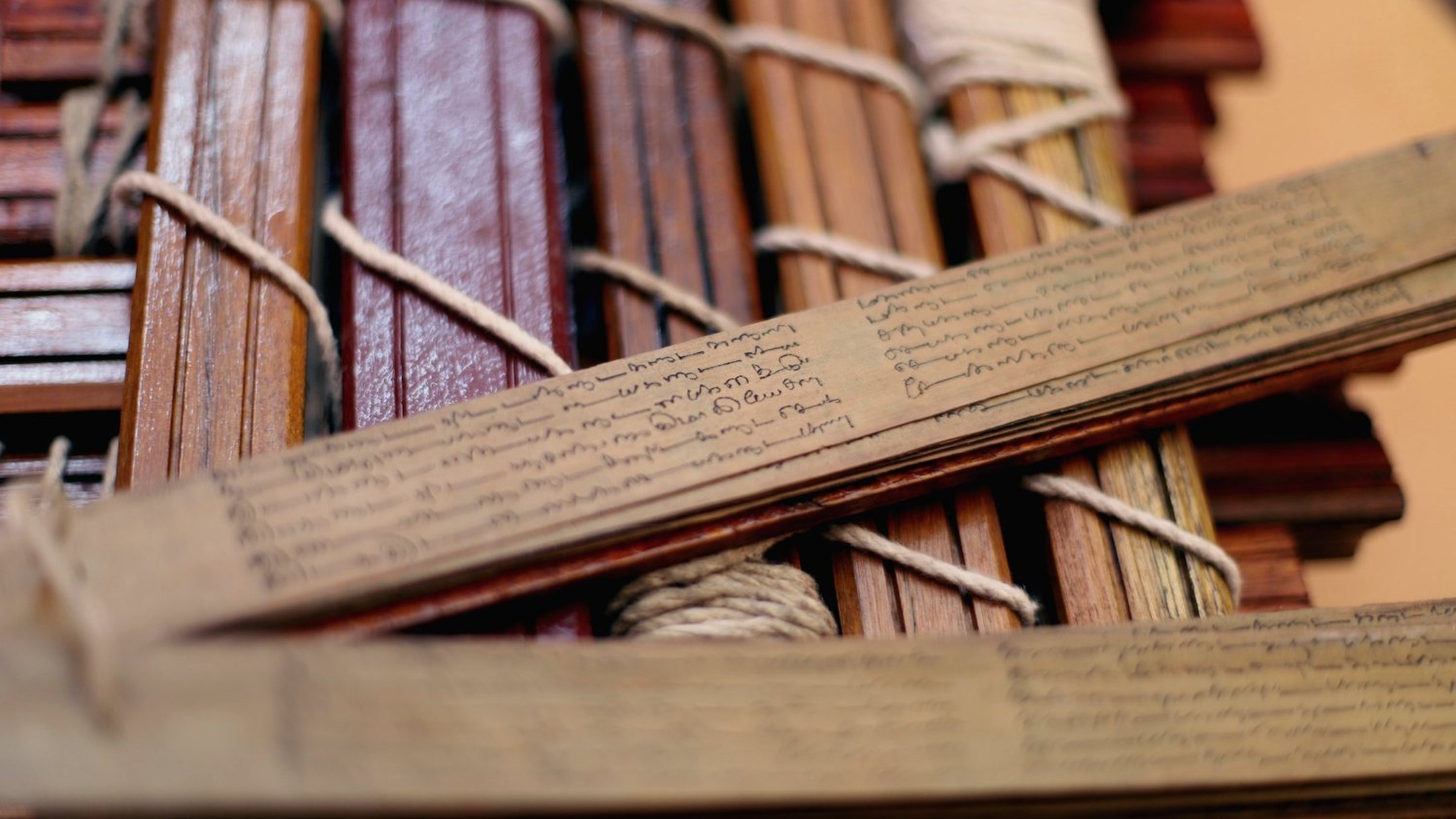 Bound palm-leaf bundles stacked in the library, waiting to be searched