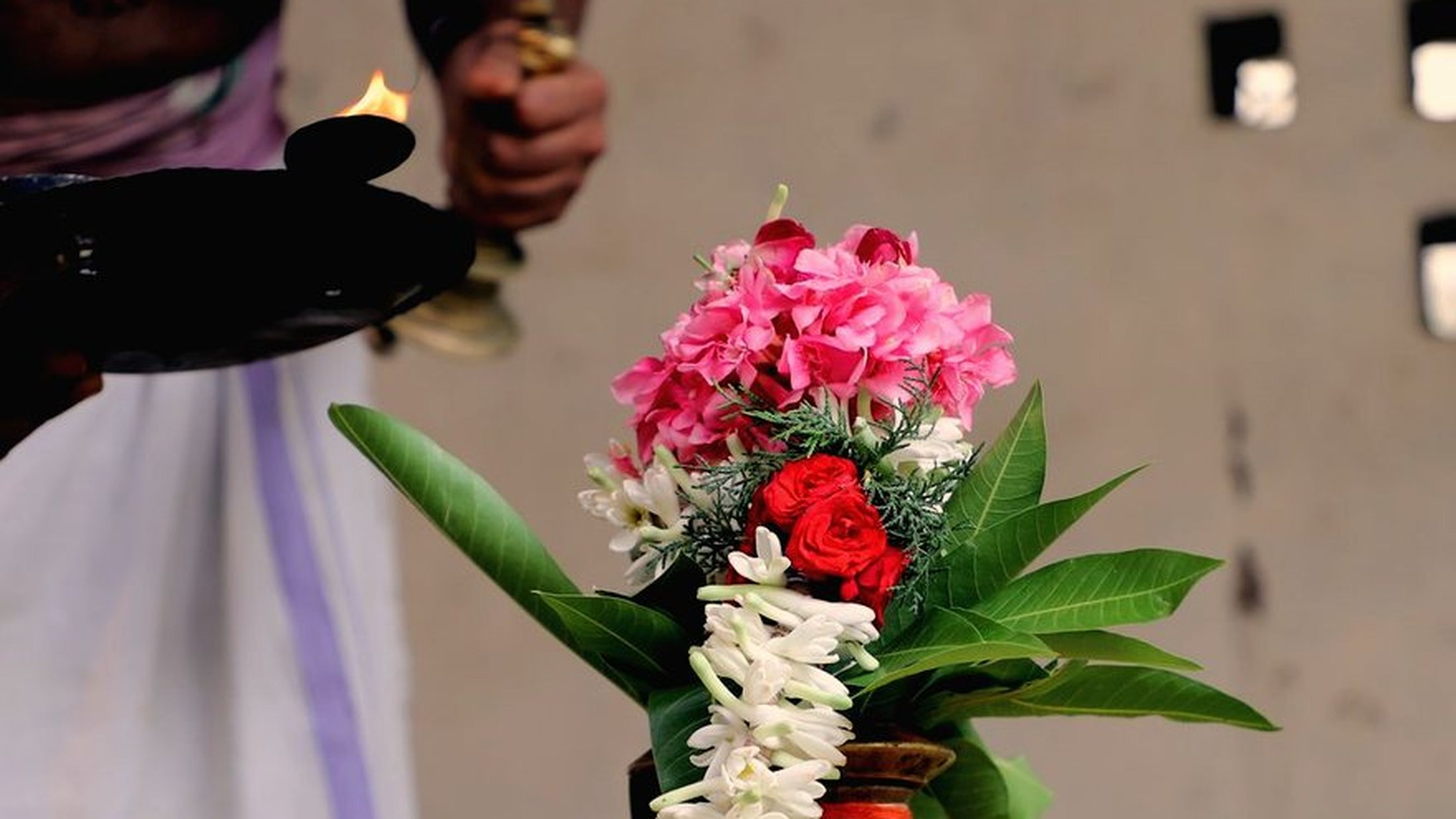 The remedy offerings set out: flowers, fruit and a lamp